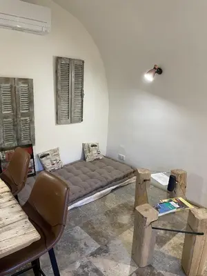 a room with a bed in the corner of a room at The Charming House in Ville-di-Paraso