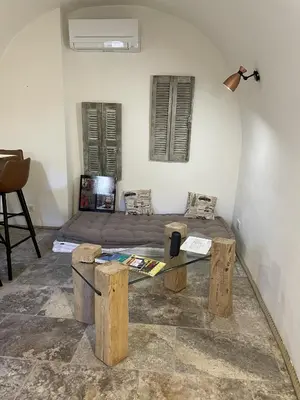 a room with two beds and a table in it at The Charming House in Ville-di-Paraso