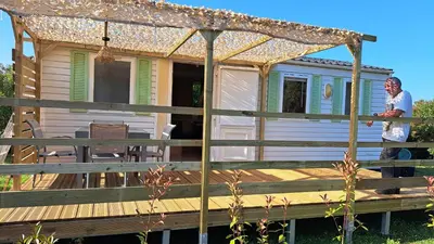 a man standing on the deck of a tiny house at Le jardin de Domi in Ventiseri