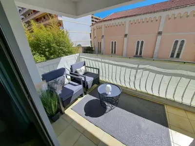a balcony with two chairs and a table on a building at Beau studio proche centre ville et plage in Ajaccio