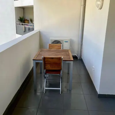 a table and two chairs in a room at Parking gratuit grande terrasse Proche Centre Ville in Ajaccio