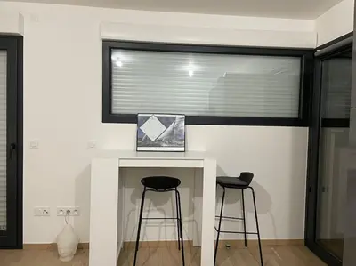 a room with two bar stools and a window at Parking gratuit grande terrasse Proche Centre Ville in Ajaccio