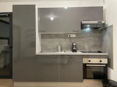 a kitchen with stainless steel cabinets and a stove at Parking gratuit grande terrasse Proche Centre Ville in Ajaccio