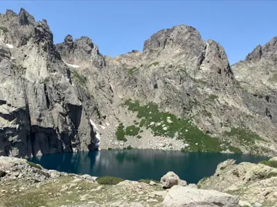 a mountain lake in the middle of a rocky mountain at Résidence Arborea C3 Corte in Corte