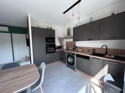 a large kitchen with a table and a dining room at Villa piscine à 1km plage proche porto vecchio in Lecci