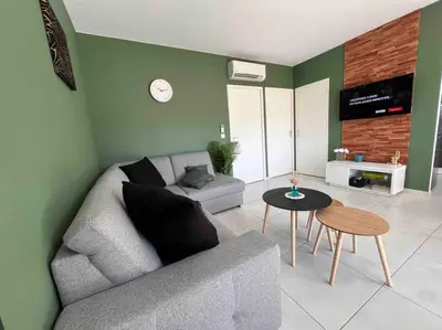 a living room with a couch and a table at Villa piscine à 1km plage proche porto vecchio in Lecci