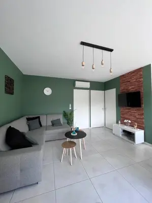 a living room with a couch and a table at Villa piscine à 1km plage proche porto vecchio in Lecci
