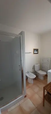 a bathroom with a shower and a toilet and a sink at Maison Maquis - la vue, le silence, la mer in Tizzano
