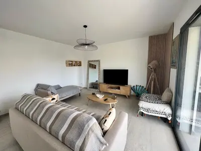 a living room with a couch and a tv at Casa Lamaghjone - Villa T4 avec piscine chauffée à 3,5km de la mer in Aléria