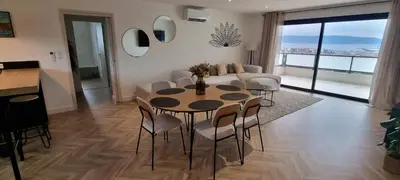 a living room with a table and chairs and a couch at Palazzu B reservation 3 nuits minimum in Ajaccio