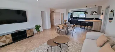 a living room and kitchen with a couch and a table at Palazzu B reservation 3 nuits minimum in Ajaccio