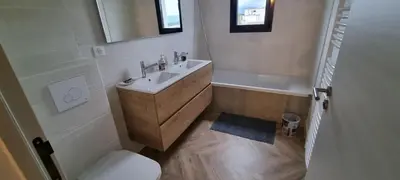 a bathroom with a sink and a toilet and a mirror at Palazzu B reservation 3 nuits minimum in Ajaccio