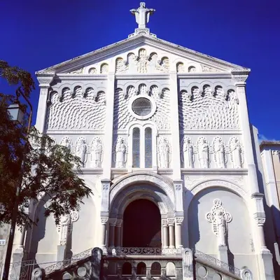 a white building with a cross on top of it at T1 Centre ville Carré d'or proche plage in Ajaccio