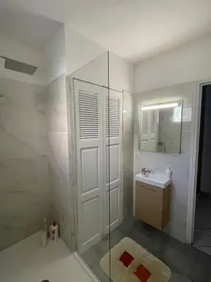 a bathroom with a shower and a sink and a mirror at T1 Centre ville Carré d'or proche plage in Ajaccio