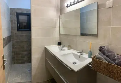 a bathroom with a sink and a mirror at CASA JEANATA in Sainte-Lucie de Porto-Vecchio