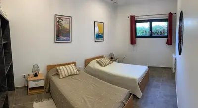 a bedroom with two beds and a window at CASA JEANATA in Sainte-Lucie de Porto-Vecchio