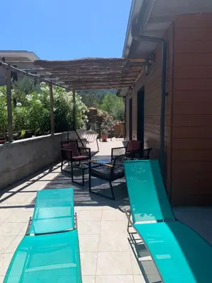 two blue chaise lounges on a patio at CASA JEANATA in Sainte-Lucie de Porto-Vecchio