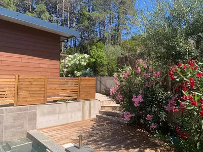 a garden with flowers next to a house at CASA JEANATA in Sainte-Lucie de Porto-Vecchio