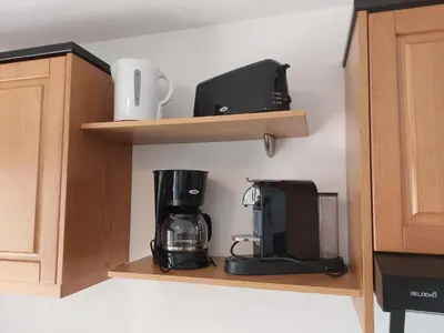 a coffee maker on a shelf in a kitchen at NOUVEL LOCATION d'un Bel appart T2 climatisé et meublé au RDCh avec piscine dans residence les Melody in Santa-Maria-Poggio