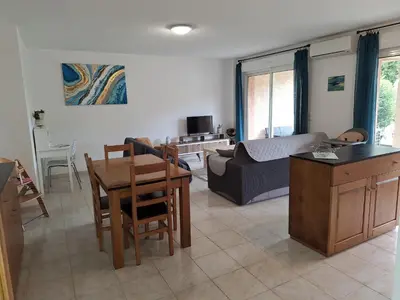 a living room with a couch and a table at NOUVEL LOCATION d'un Bel appart T2 climatisé et meublé au RDCh avec piscine dans residence les Melody in Santa-Maria-Poggio