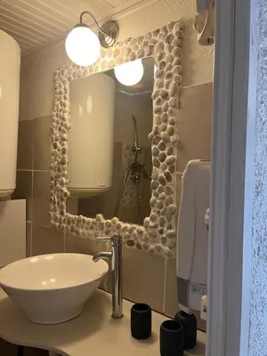 a bathroom with a sink and a mirror at L’oléado in Oletta