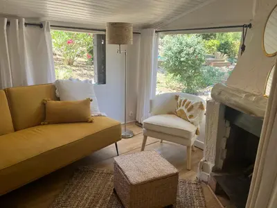 a living room with a couch and a chair and a fireplace at L’oléado in Oletta