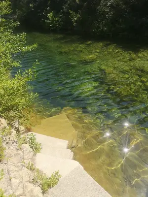 a large body of water with rocks and trees at Evasion in Ventiseri