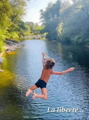 a young child jumping into a body of water at Evasion in Ventiseri