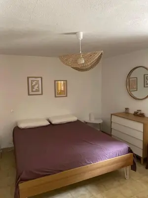 a bedroom with a bed and a mirror and a lamp at Sartène - Villa - 16 pers - 8 pièces - 6 chambres in Foce