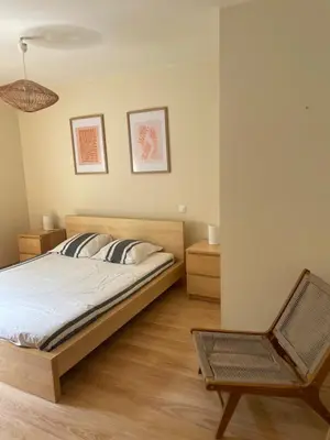a bedroom with a bed and a chair at Sartène - Villa - 16 pers - 8 pièces - 6 chambres in Foce