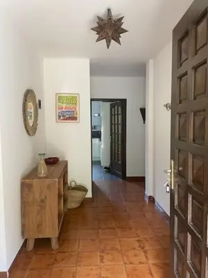 a hallway with a room with a door and a table at Sartène - Villa - 16 pers - 8 pièces - 6 chambres in Foce
