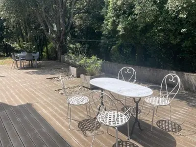 a table and four chairs and a table and a table and chairs at Sartène - Villa - 16 pers - 8 pièces - 6 chambres in Foce