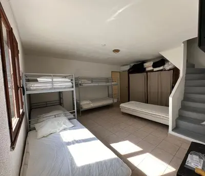 a room with two bunk beds and a staircase at Sartène - Villa - 16 pers - 8 pièces - 6 chambres in Foce