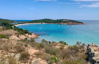 a view of a beach with boats in the water at Appart T3 4 étoiles 4/6 personnes Porto Vecchio in Porto-Vecchio