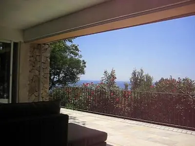 a living room with a large sliding glass door to a balcony at panopé in Porto-Vecchio