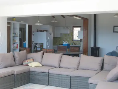 a living room with a couch and a kitchen at panopé in Porto-Vecchio