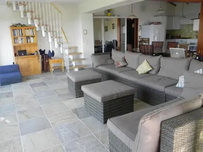 a living room with couches and tables and a kitchen at panopé in Porto-Vecchio