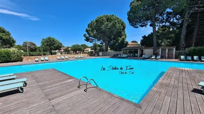 a swimming pool with a sign on the side of it at Les Studios de Fiori - Studios et Appartement T2 - Cala Rossa - proche Porto Vecchio in Lecci