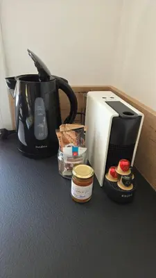 a coffee maker and a toaster sitting on the floor at Les Studios de Fiori - Studios et Appartement T2 - Cala Rossa - proche Porto Vecchio in Lecci