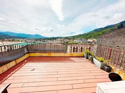 a balcony with a view of a city at Magnifique duplex de 130 m² à Corte (centre ville) in Corte