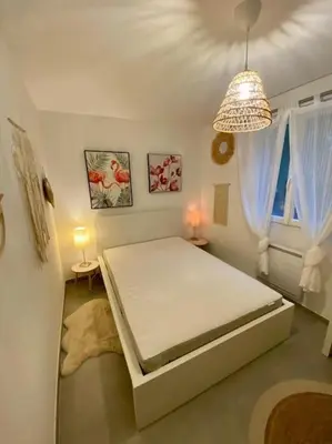 a bedroom with a white bed in a room at Maison de vacances in Ventiseri