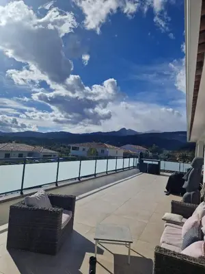 a balcony with chairs and a view of the mountains at VILLA entre mer, montagnes, étangs et rivières in Ventiseri