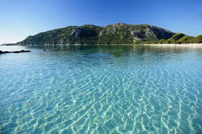 a large body of water with an island in the background at Appartement moderne Santa Giulia in Porto-Vecchio