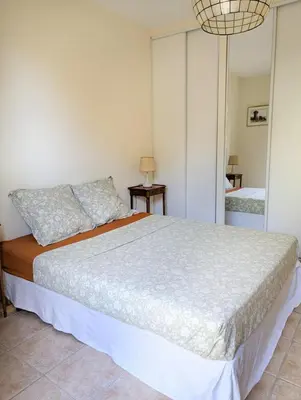 a bedroom with a large bed in a room at Magnifique villa entre mer et montagne in Calenzana