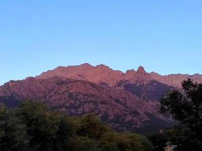 a mountain range with trees in front of it at Magnifique villa entre mer et montagne in Calenzana