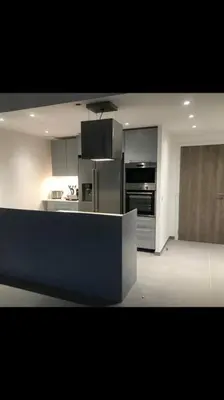 a kitchen with stainless steel appliances in a room at Domaine d'Arca Eluard 02- PORTO-VECCHIO - Rez de jardin - 2 à 4 pers in Porto-Vecchio