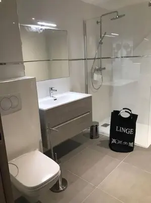a bathroom with a toilet and a sink and a shower at Domaine d'Arca Eluard 02- PORTO-VECCHIO - Rez de jardin - 2 à 4 pers in Porto-Vecchio