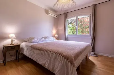 a bedroom with a large bed and a window at L'Orangeraie - Maison avec vue pour 12 voyageurs in Grosseto-Prugna