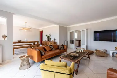 a living room with a couch and a table at L'Orangeraie - Maison avec vue pour 12 voyageurs in Grosseto-Prugna