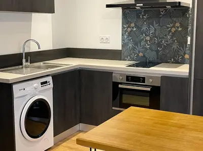 a kitchen with a washing machine and a sink at Appartement centre ville Corte (F) in Corte